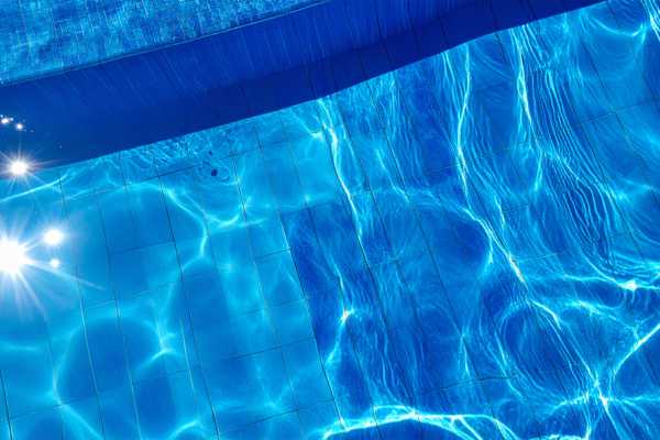 Clear blue water reflecting sunlight, showcasing a pristine pool surface, relevant to pool renovation tips for enhancing outdoor spaces. Clear blue water reflecting sunlight, showcasing a pristine pool surface, relevant to pool renovation tips for enhancing outdoor spaces.